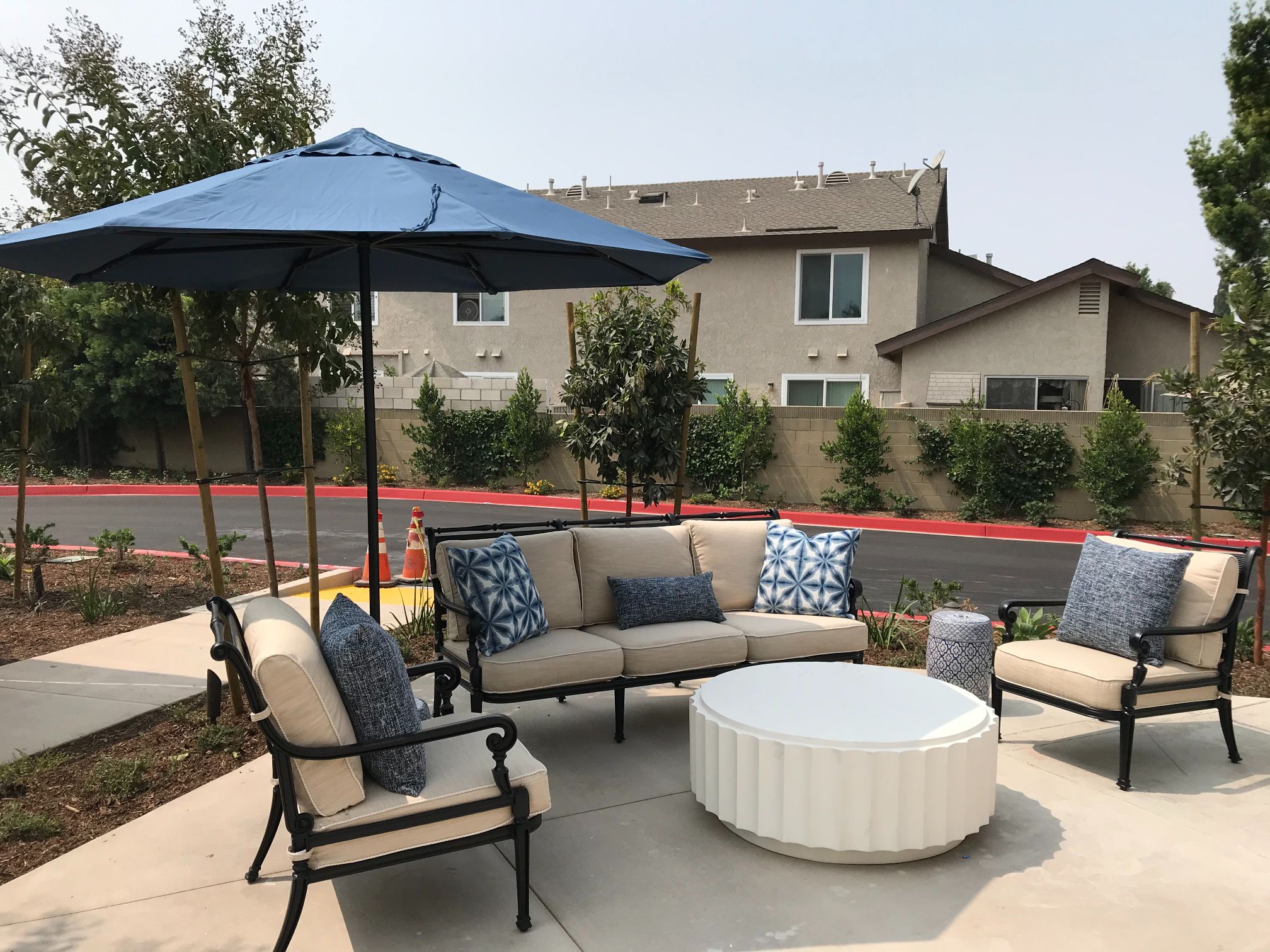 Outdoor kitchen, grill, dining table, and lounge space The Retreat Midway City 33.74528228124775, -117.99286921960925